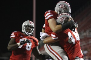 After a TD, UNLV offensive lineman Robert Waterman hugs tight end Jake Phillips in the end zone in the second quarter.