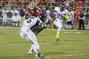 UNLV wide receiver Anthony Williams hangs on to the football after taking a hit from Martinez Davis in the third quarter.
