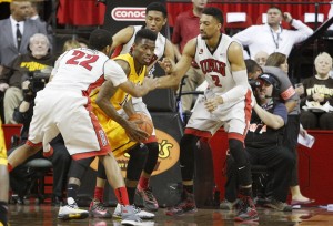 UNLV defenders surround Wyoming forward Derek Cooke Jr. in the first half of UNLV's MWC quarterfinal game against Wyoming.