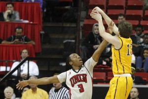 UNLV guard Kevin Olekaibe tries to block a Jack Bentz 3-pointer in the first half of UNLV's MWC quarterfinal game against Wyoming.