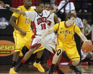 UNLV guard Daquan Cook defends Wyoming guard Riley Grabau in the first half of UNLV's MWC quarterfinal game against Wyoming.