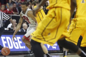 UNLV guard Bryce Dejean-Jones dribbles before hitting a jumper to beat the buzzer in the end of the first half of UNLV's MWC quarterfinal game against Wyoming.