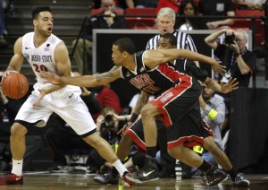 UNLV guard Bryce Dejean-Jones tries to steal the ball away from SDSU forward JJ O'Brien in the first half of UNLV's MWC semifinal game against San Diego St.