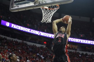 UNLV center Khem Birch jumps up for a slam dunk in the first half of UNLV's MWC semifinal game against San Diego St.