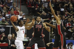 UNLV's Khem Birch and Bryce Dejean-Jones trap SDSU guard Xavier Thames in the second half of UNLV's MWC semifinal game against San Diego St.